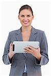 Smiling tradeswoman with her touchscreen computer against a white background