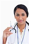 Close up of female doctor with syringe against a white background