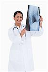 Smiling female physician with x-ray against a white background