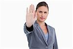 Tradeswoman signalizing stop against a white background