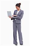 Smiling female entrepreneur working on her laptop against a white background