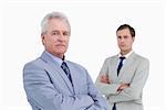 Serious tradesmen with arms folded against a white background