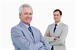 Smiling tradesmen with arms folded against a white background