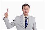 Close up of businessman pointing up against a white background