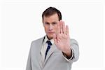 Close up of businessman's palm signalizing stop against a white background