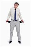 Sad businessman showing his empty pockets against a white background