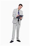 Smiling businessman taking notes against a white background