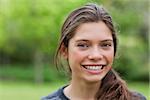 Young woman looking at the camera while showing a beaming smile