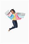 Latin student jumping with shopping bags against white background