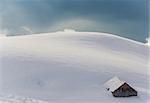 Mountain hut in the French alps covered with snow.