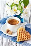 Sweet heart waffle and cup of coffee with brown sugar.