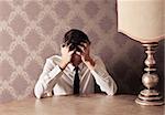 Elegant young man at a table desperated