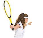 Tennis player ready to hit ball. rear view