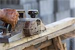 Carpenter working with electric planer  in his workshop, close up on the tool with hands