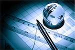 Business concept. Glass globe near ruler on paper background with chart