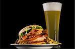 Big Burger with Bacon, Cheese, Lettuce French Fries Wheat Beer Glass iolated on black background