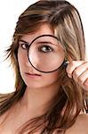 Woman looking trough a magnifying glass, isolated in a white background