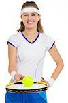 Closeup on tennis player balancing ball on racket