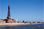 Blackpool waterfront and beach with Blackpool Tower, a historical Victorian lattice structure, overlooking the ocean