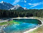 reflections in the famous lake of Carezza - Dolomites, Italy