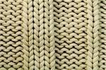 Old knit sweater background. Beige color. Studio shot