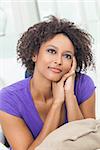 A beautiful mixed race African American girl or young woman looking happy and thoughtful