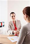 Businesswomen Shaking Hands in Office