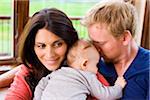 Couple Hugging and Snuggling with Three Month Old Son