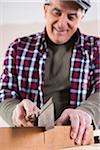 Man Cutting Lumber, Woodworking Project, in Studio