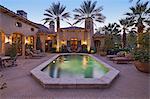 Rear entrance  of luxury villa at night with swimming pool