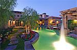 Shooting water outside House Exterior with swimming pool and hot tub