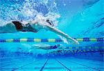 Four female swimmers racing together in swimming pool