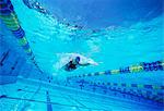 Young female swimmer in competition