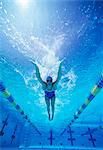 Full length of female swimmer in United States swimsuit swimming in pool