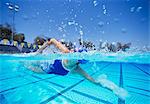 Female swimmer in United States swimsuit swimming in pool