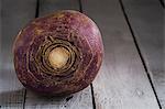 A turnip on a wooden surface