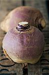 Two turnips on a wooden crate