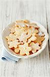 Flower-shaped biscuits dusted with icing sugar