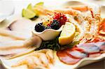 A plate of mixed starters with prawns and carpaccio of tuna and of swordfish