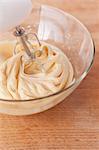 Cake mixture being prepared in a glass bowl using a mixer