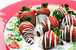 Strawberries coated with white and dark chocolate