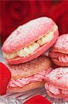 Strawberry and raspberry macaroons with buttercream filling and rose petals