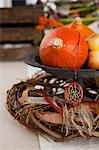 An autumnal table decoration with pumpkins and a dream-catcher