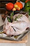 Turkey with herbs on a baking tray