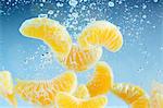 Mandarin segments falling through water