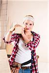 Studio Shot of Young Woman Carrying Lumber