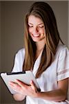 Woman sitting using an ipad.