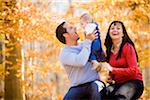 Couple Playing with their Four Month Old Daughter, at Scanlon Creek Conservation Area, near Bradford, Ontario, Canada