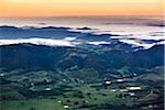 Aerial view of wine country near Pokolbin as mist comes in over the Brokenback Range, Hunter Valley, New South Wales, Australia