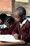 African school pupil working hard at his desk